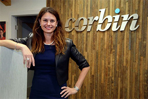 Founder & CEO, Rebecca Corbin at the Corbin sign in the Farmington, CT Headquarters