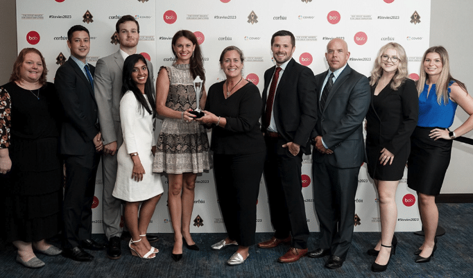 Rebecca Corbin, Founder and CEO of Corbin Advisors with Corbin team members at the after winning the Silver 2023 Stevie® Award Winner for Employer of the Year in the Financial Services Industry
