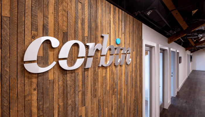 Grand Opening 2020 of the new Corbin Advisors headquarters in Farmington, CT: featuring the wood panel wall with the Corbin logo
